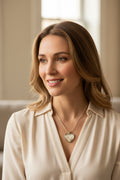 Heart-shaped pendant necklace with Let go Let God on a white background