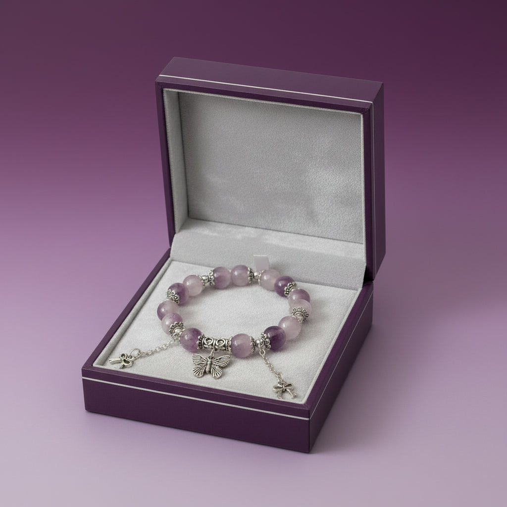 Purple Beaded bracelet with butterfly charms on a light background