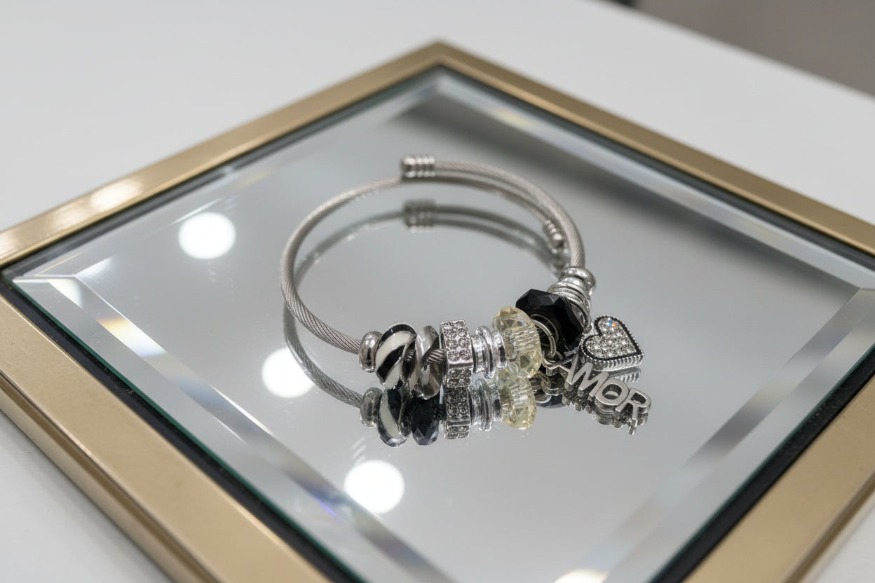 Silver bracelet with charms on a light gray background